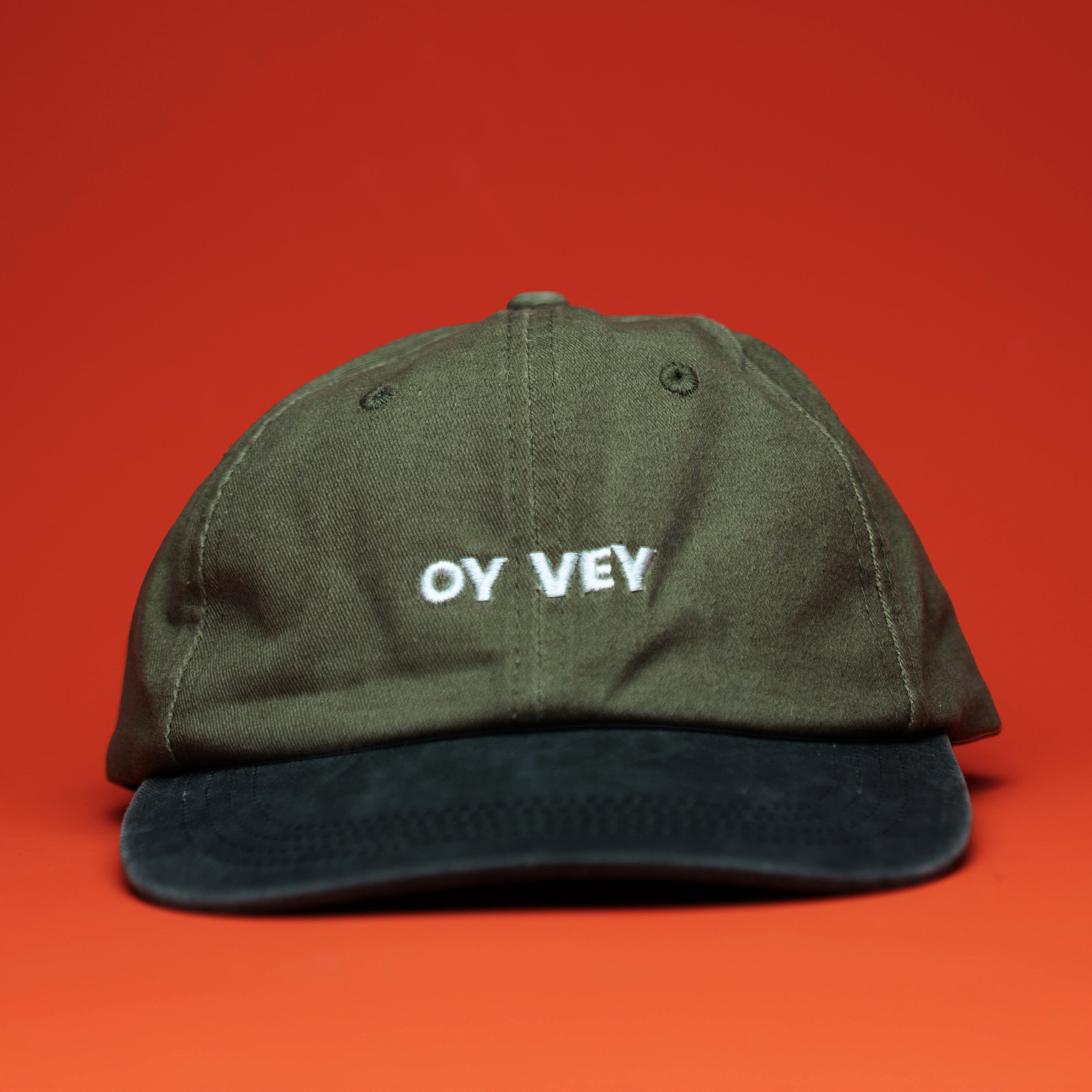 Green cap with 'OY VEY' text on a red background