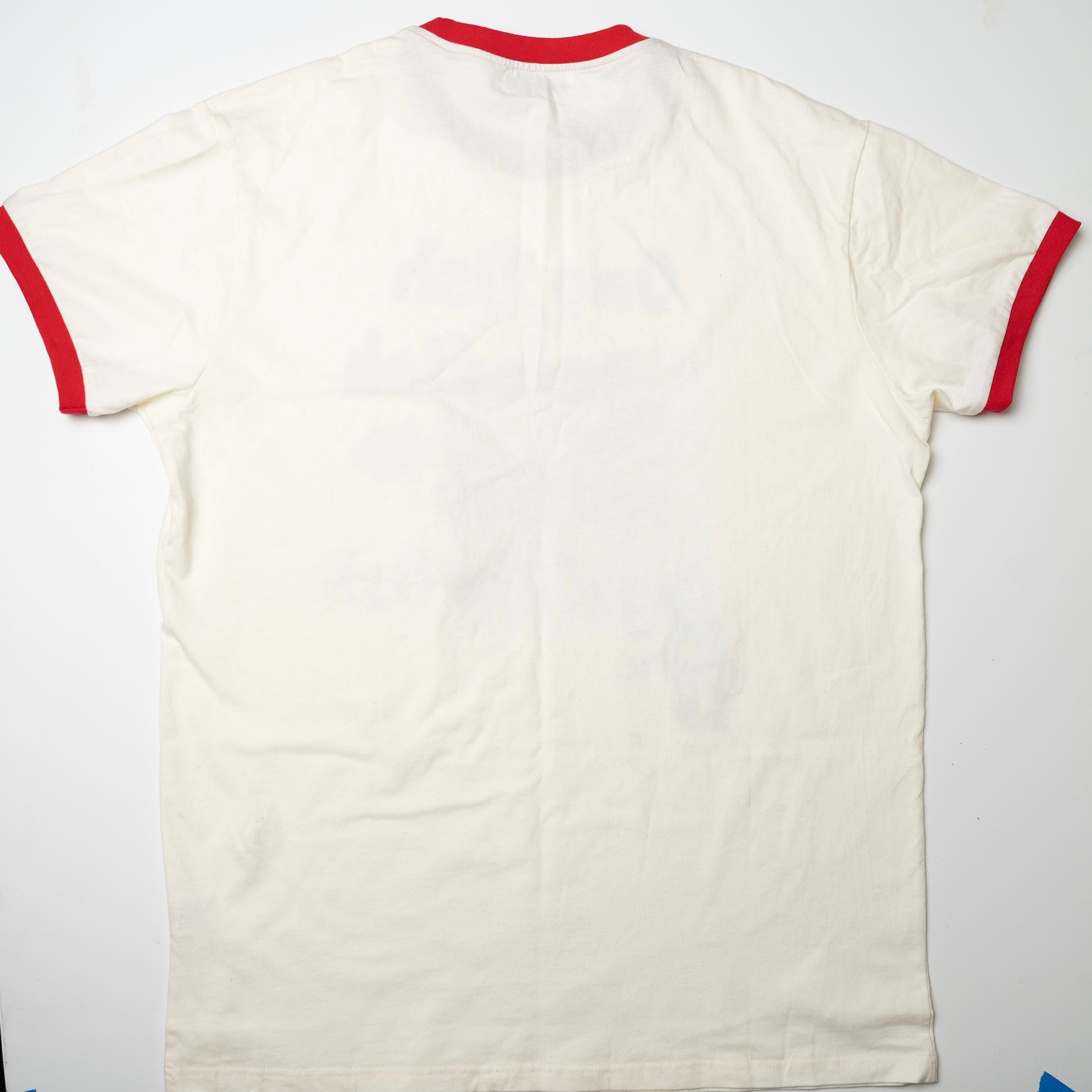 White t-shirt with red trim on a white background