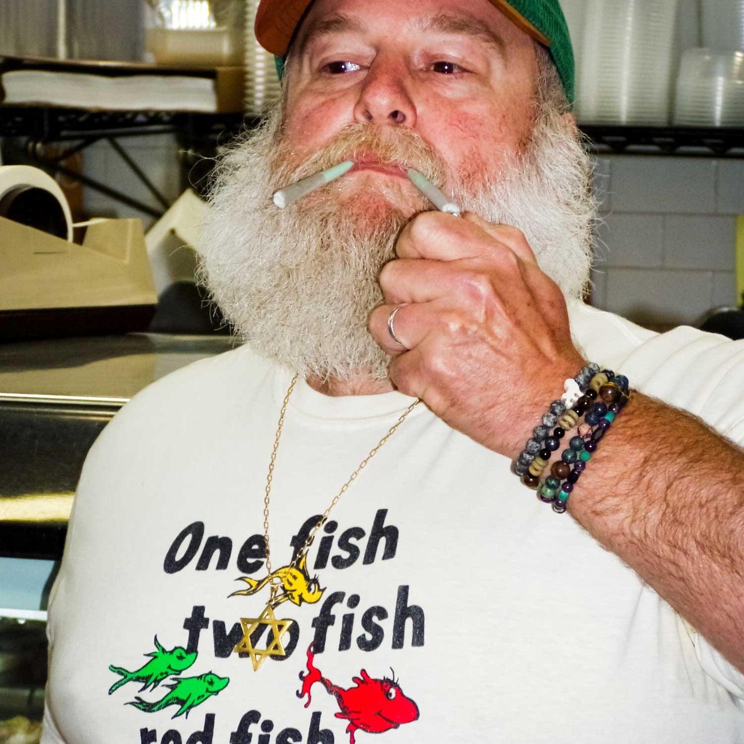 Man smoking while wearing One Fish shirt