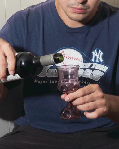 Video of man pouring wine into kiddush cupe pipe then smoking out of it