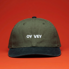 Green cap with 'OY Vey' text on a red background